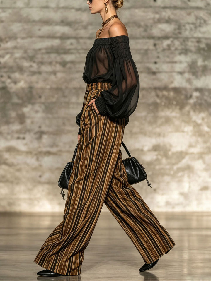 Elegante top nero off-the-shoulder e set di pantaloni a gamba larga a righe