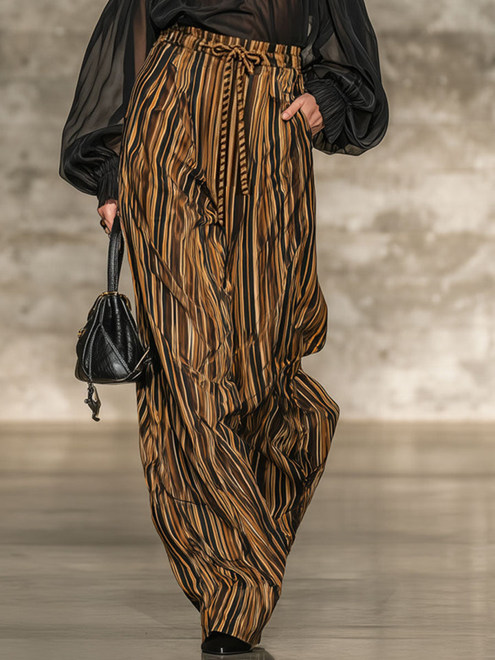 Set elegante con top nero off-the-shoulder e pantaloni a righe a gamba larga