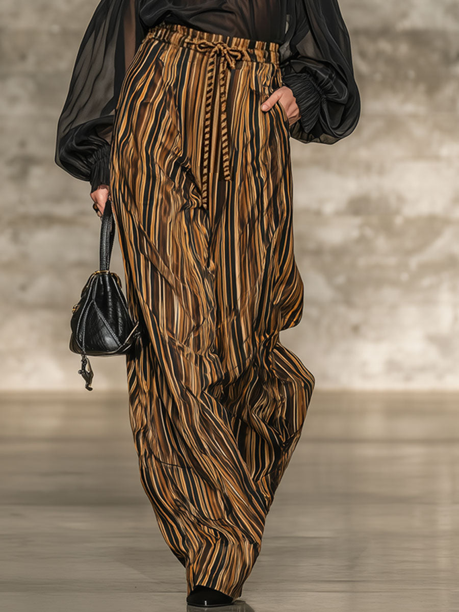Elegante top nero off-the-shoulder e set di pantaloni a gamba larga a righe