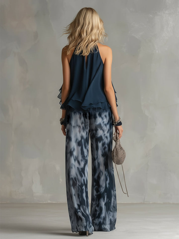Chloé | Completo elegante con top a schiena nuda blu navy e pantaloni larghi stampati